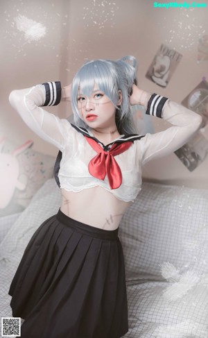 A woman in a white shirt and black skirt posing for a picture.
