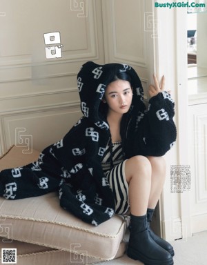 A woman sitting on a couch in a living room.