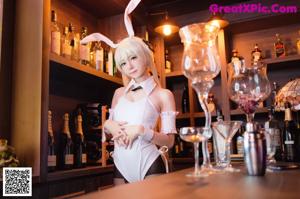 A woman sitting on top of a stool in a bunny costume.