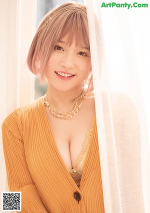 A woman in a yellow lingerie posing for a picture.