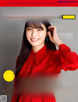 A woman in a red jacket is looking at the camera.