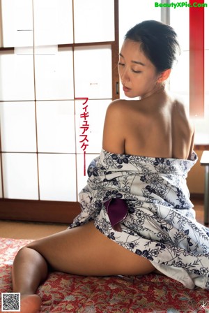 A woman in a purple lingerie sitting on a chair.