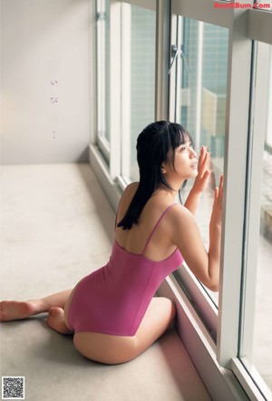 A woman in a white lingerie laying on a bed.