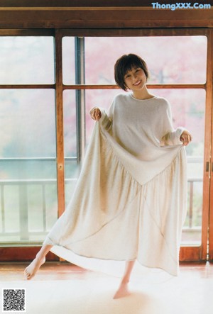 A woman in a yellow suit on the cover of a magazine.