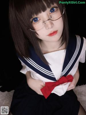 A woman in a sailor outfit is sitting on a white rug.