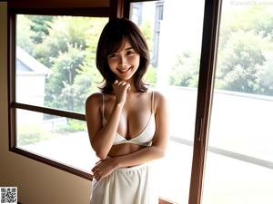 A nude woman standing in front of a window.