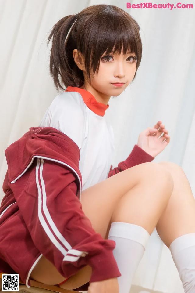 A woman in a school uniform sitting on a chair.